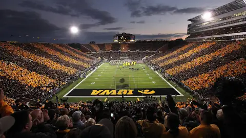 Full Iowa football stadium at dusk before kickoff
