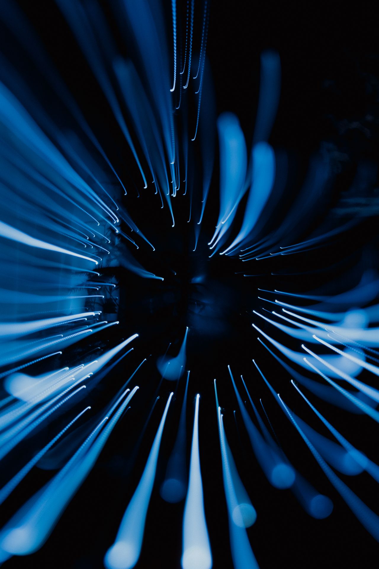 Abstract burst of blue light trails radiating outward, representing the many possible reasons behind a single checkout drop-off