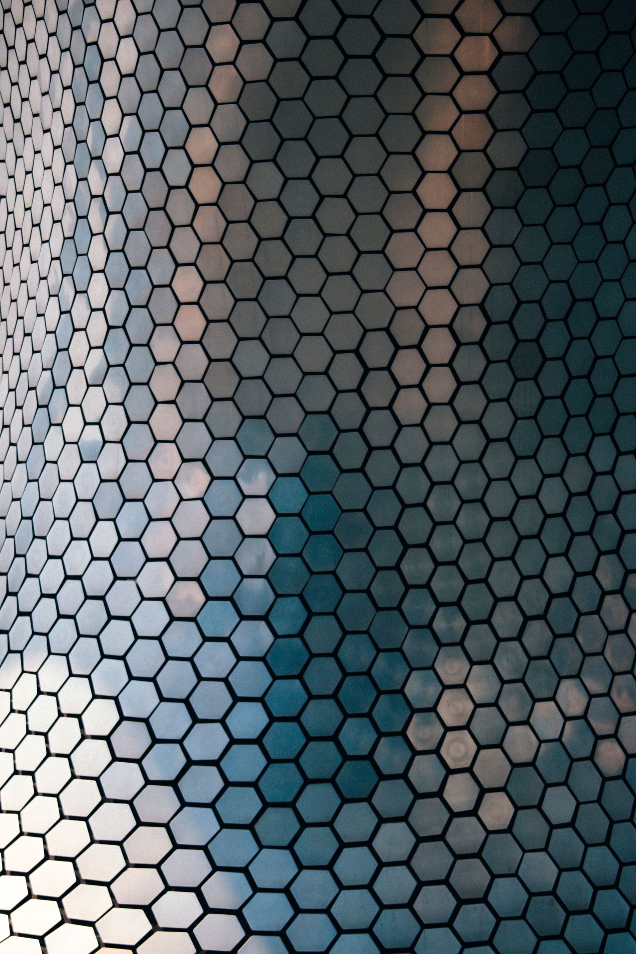 Close-up of a reflective hexagonal grid pattern, representing the repeating data points behind local search visibility