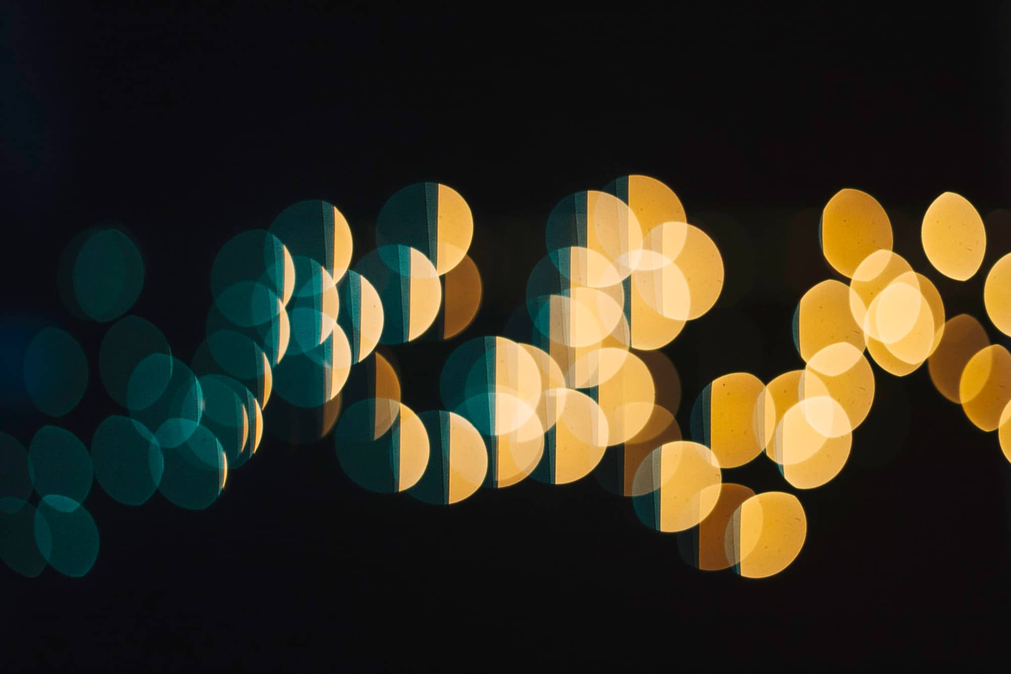 Rows of soft bokeh lights in teal and gold, representing accumulating measurement signals